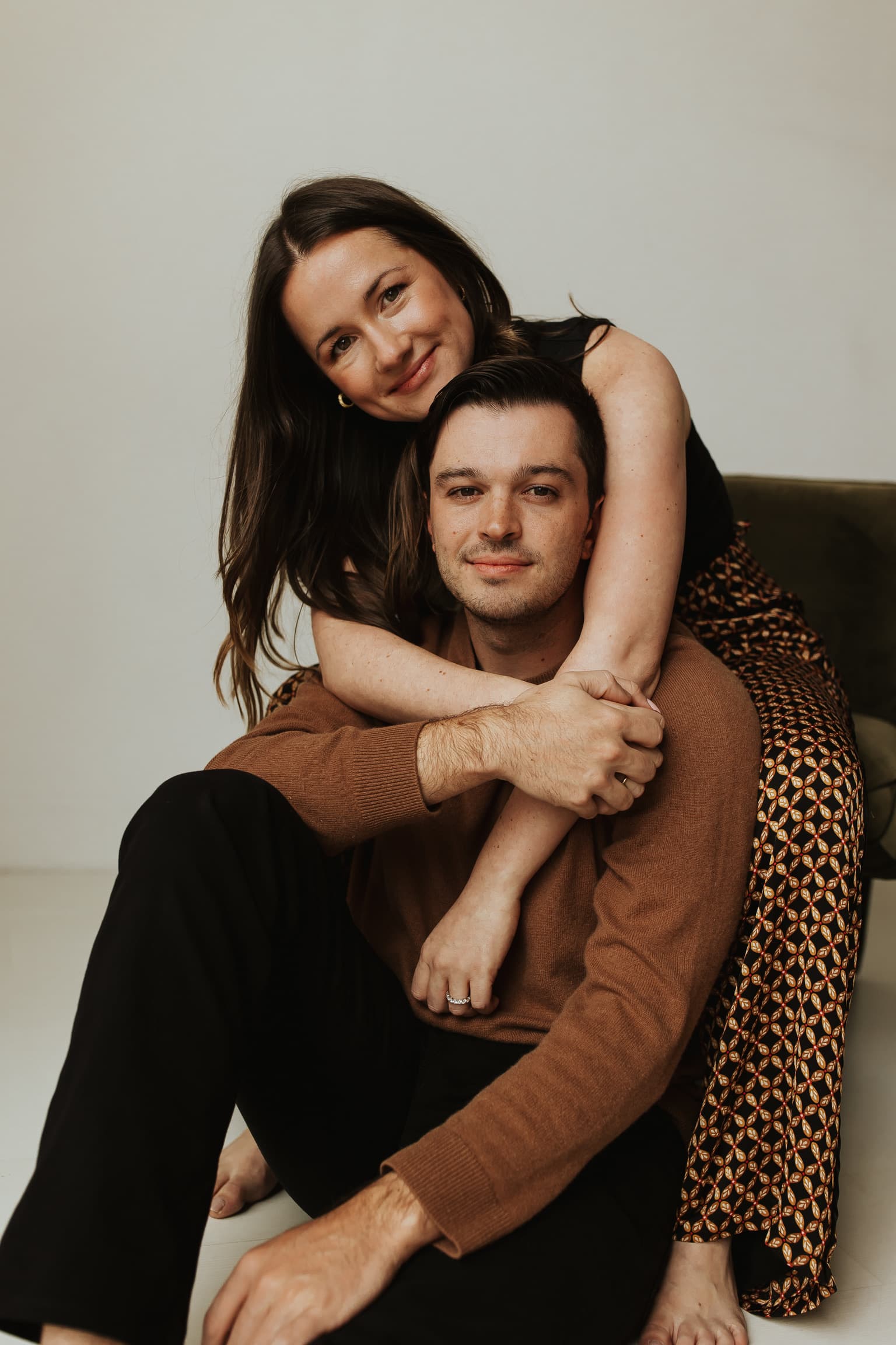 A photo of Molly and John soft smiling from their engagement photo shoot